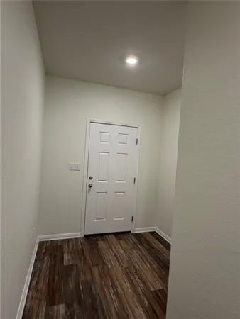 a view of hallway with wooden floor