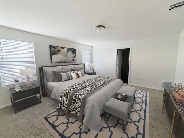 a bedroom with a bed and a couch