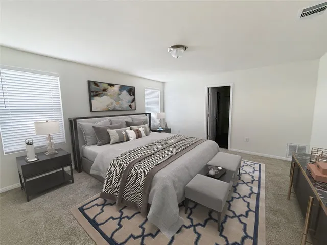 a bedroom with a bed and a couch