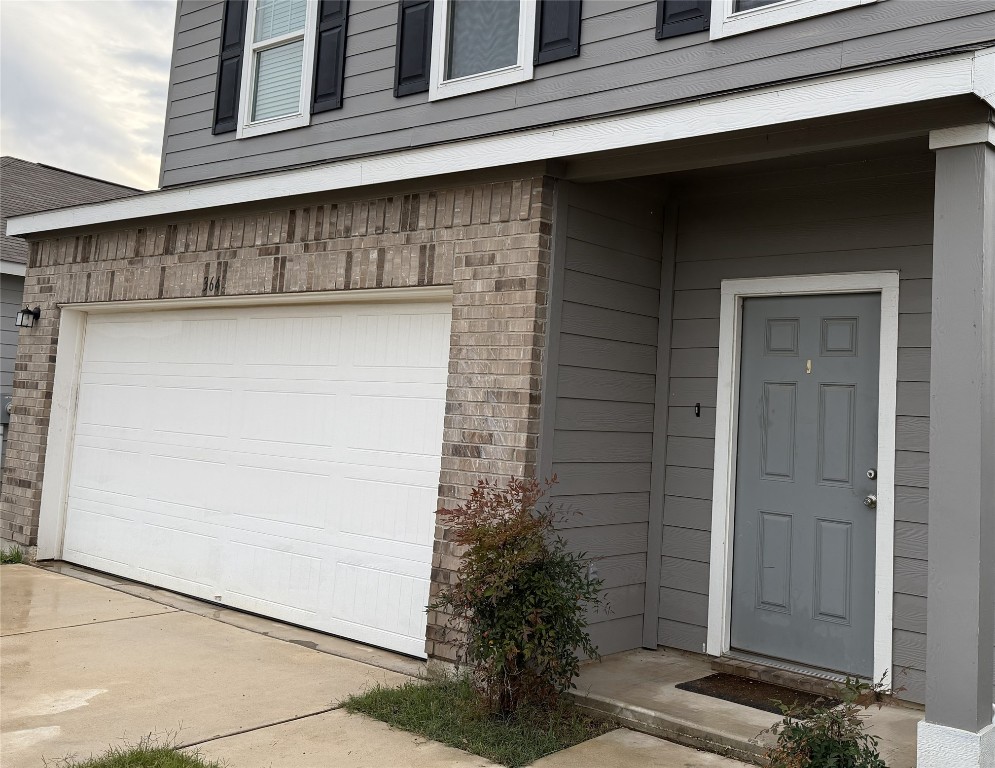 364 Bell Rings Drive Jarrell, TX 76537 - Photo 2 of 25 Entrance to property featuring brick siding and an attached garage
