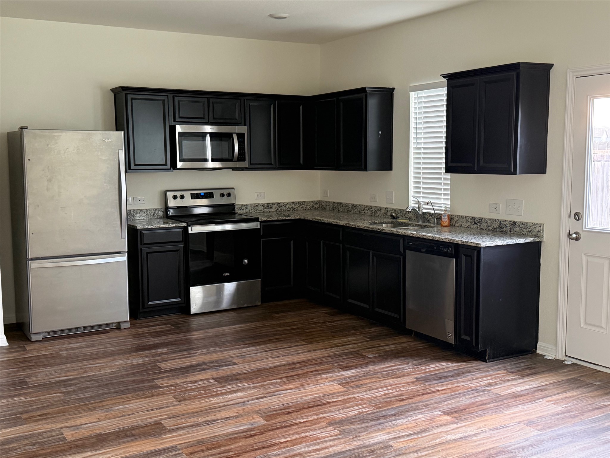 364 Bell Rings Drive Jarrell, TX 76537 - Photo 4 of 25 a kitchen with stainless steel appliances granite countertop a sink a stove a refrigerator and cabinets