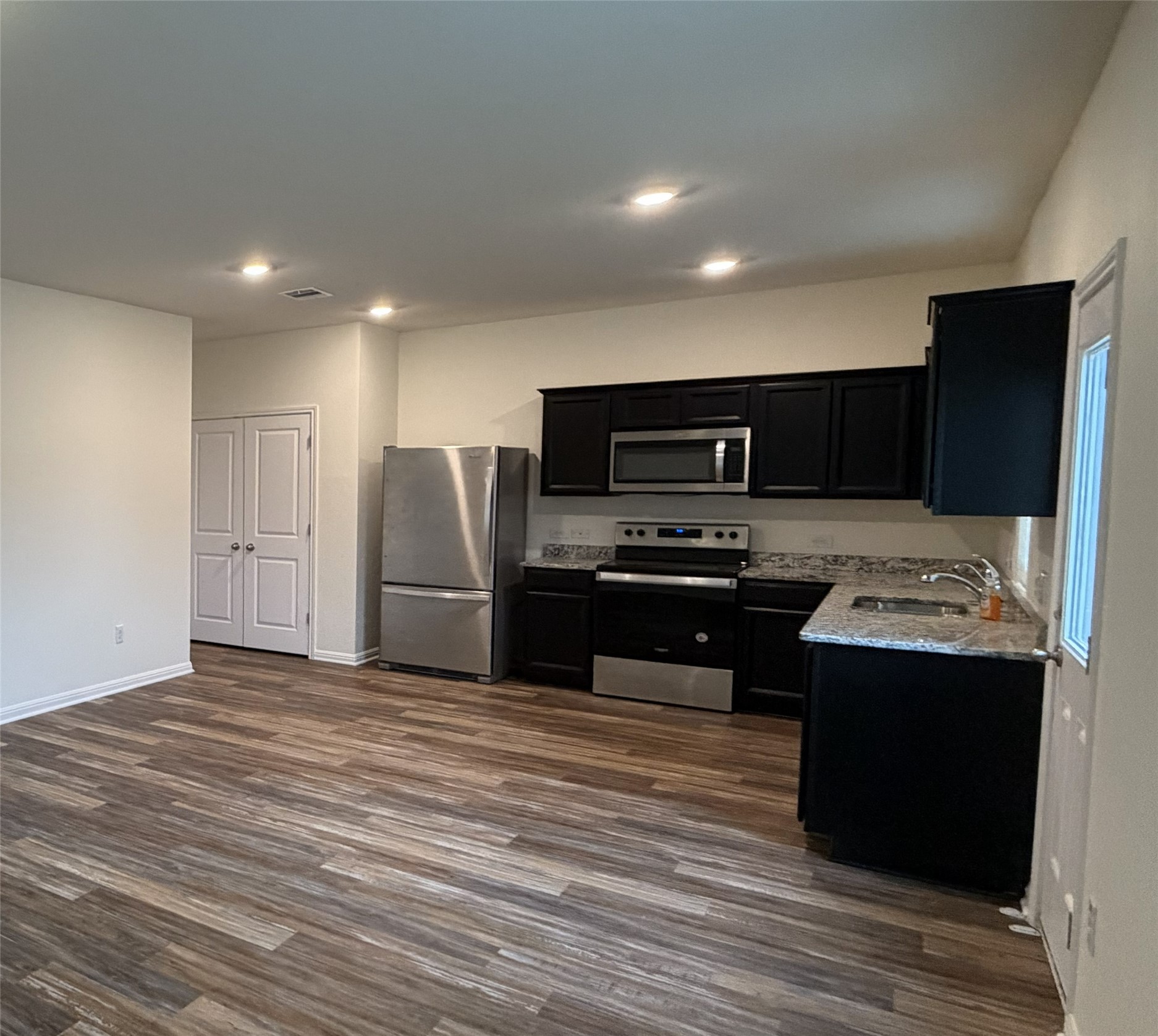364 Bell Rings Drive Jarrell, TX 76537 - Photo 5 of 25 a kitchen with a refrigerator and a stove top oven