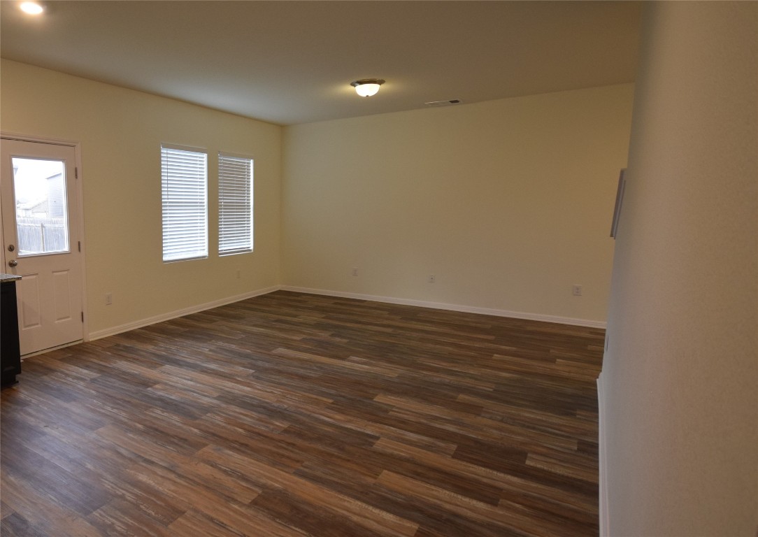 364 Bell Rings Drive Jarrell, TX 76537 - Photo 8 of 25 Spare room featuring dark wood-style floors and baseboards
