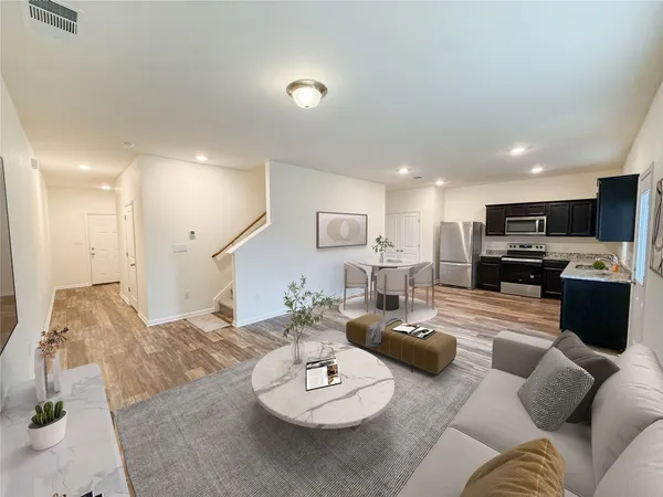 a view of kitchen with kitchen island stainless steel appliances refrigerator stove microwave and cabinets