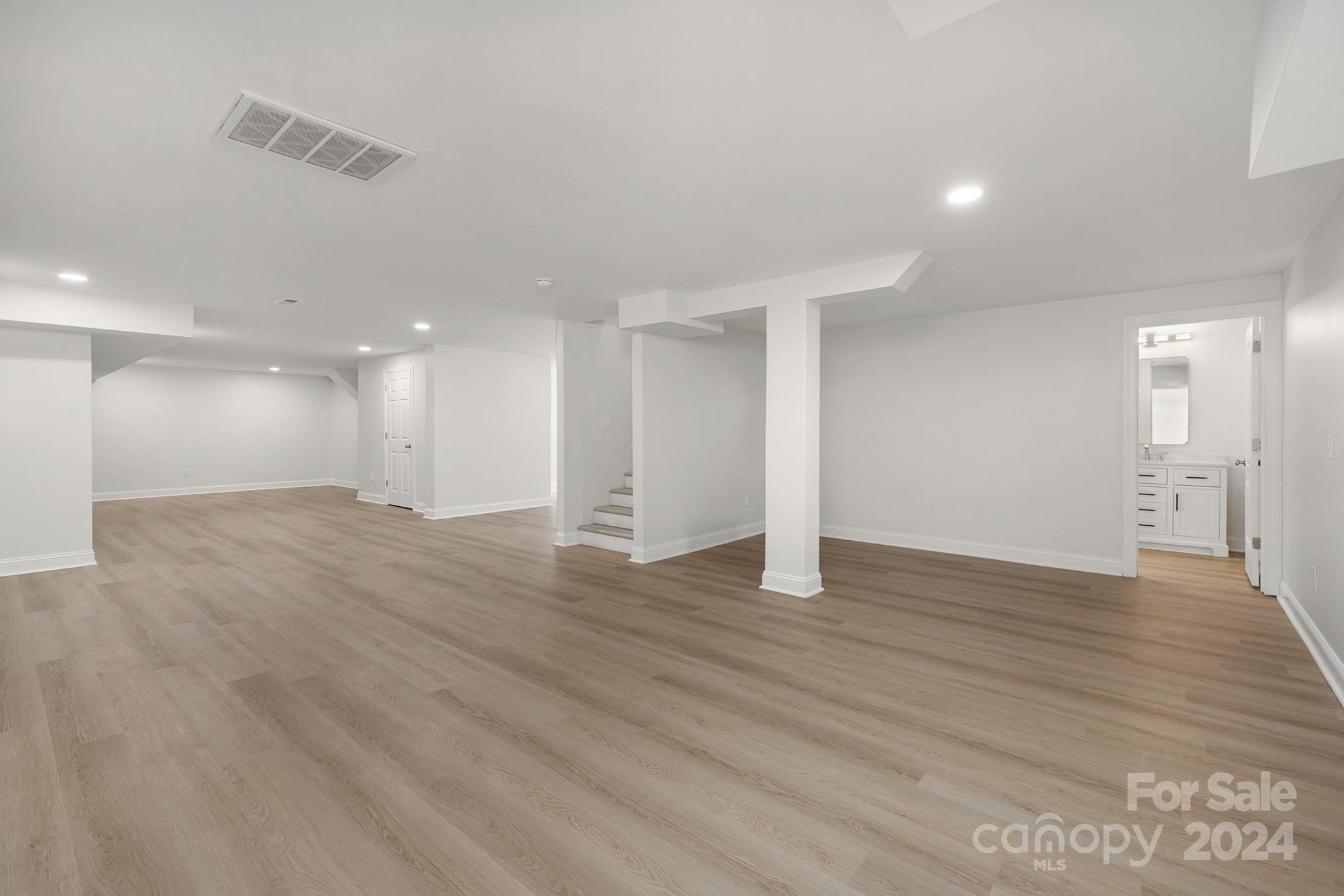 1234 Midway Road Statesville, NC 28625 - Photo 17 of 25 a view of an empty room with wooden floor and a window
