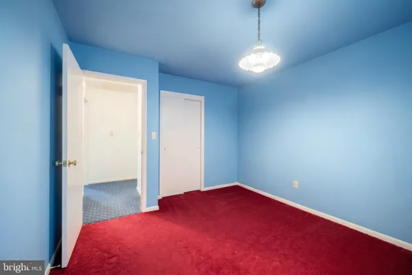 a view of empty room with window and wooden floor