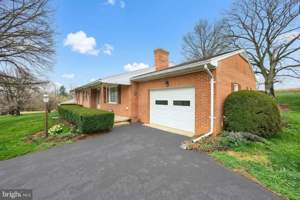 a view of a house with a yard and garage