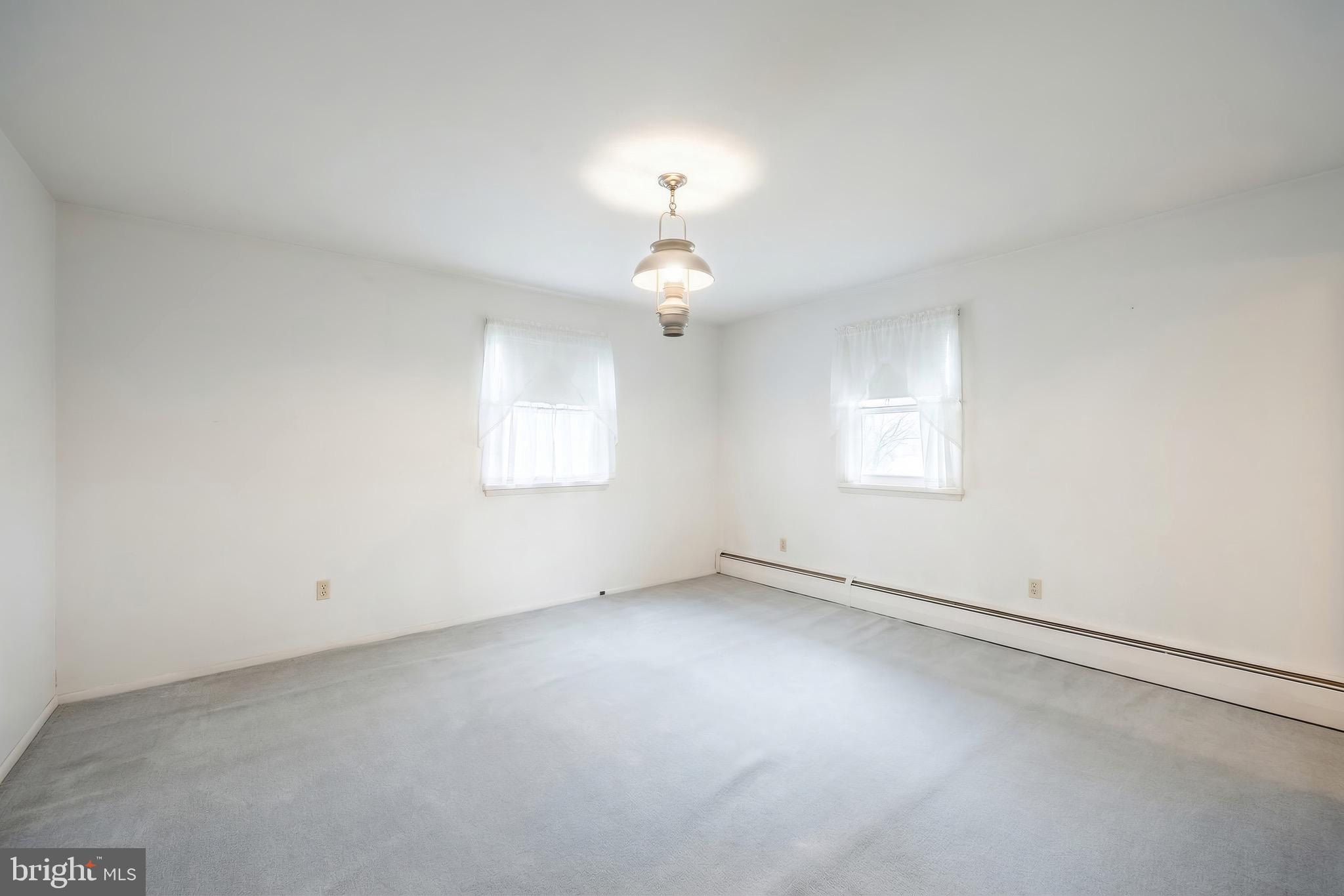 145 Mt Tabor Road Aspers, PA 17304 - Photo 21 of 40 an empty room with a chandelier fan and windows