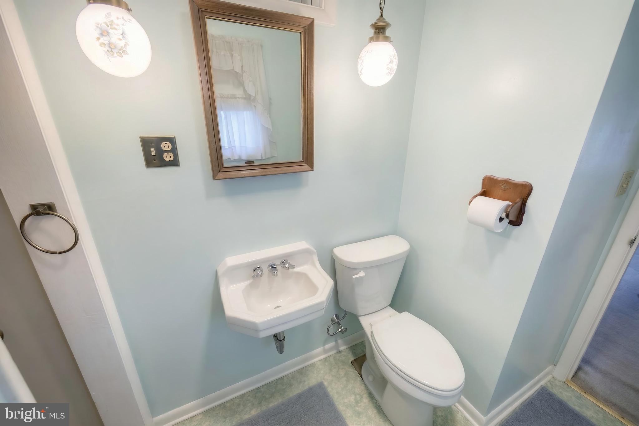 145 Mt Tabor Road Aspers, PA 17304 - Photo 22 of 40 a white toilet sitting next to a bathroom sink and a mirror