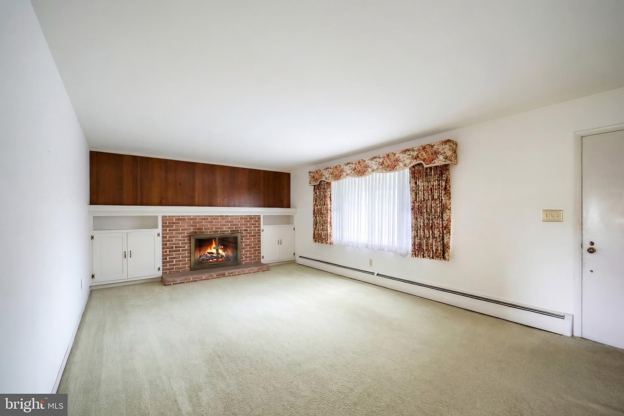 145 Mt Tabor Road Aspers, PA 17304 - Photo 8 of 40 an empty room with fireplace and windows