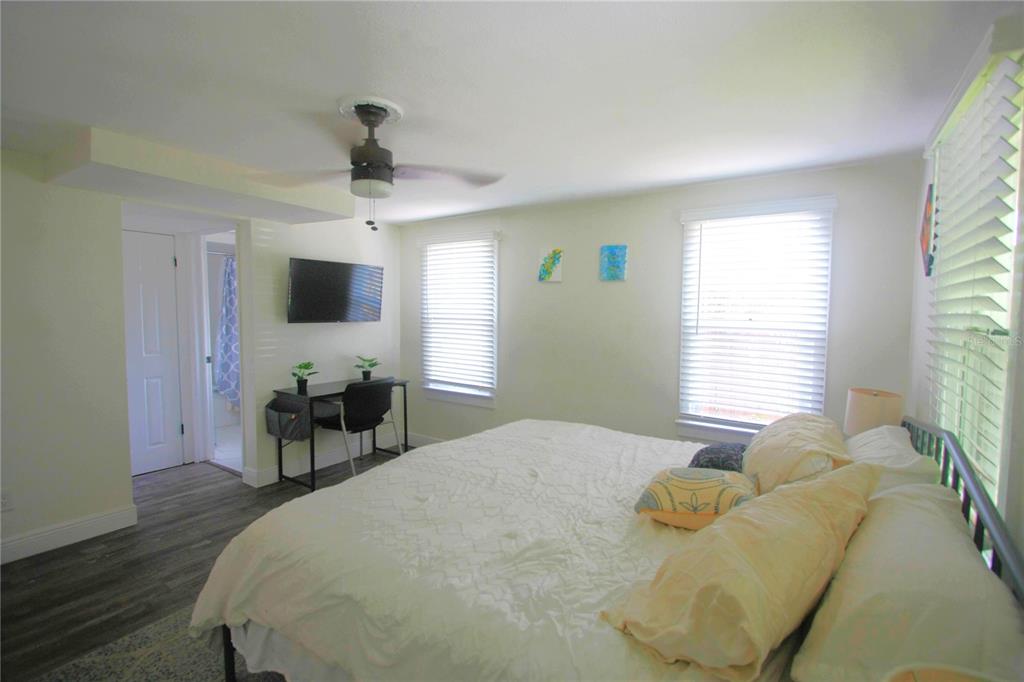 6602 North 9th Street Tampa, FL 33604 - Photo 12 of 22 a bedroom with a bed and a flat screen tv