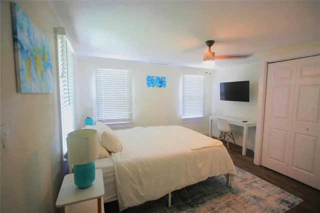 a bedroom with a bed and a flat screen tv