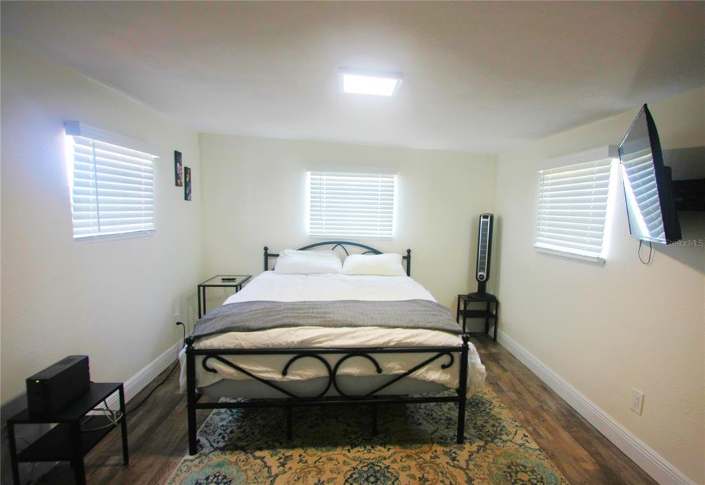 6602 North 9th Street Tampa, FL 33604 - Photo 17 of 22 a bed sitting in a bedroom next to a window