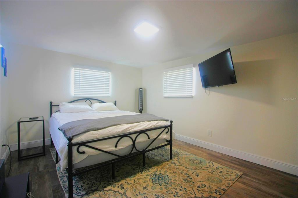 6602 North 9th Street Tampa, FL 33604 - Photo 18 of 22 a bedroom with a bed and a flat screen tv