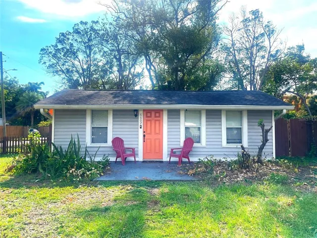 a front view of a house with yard and porch
