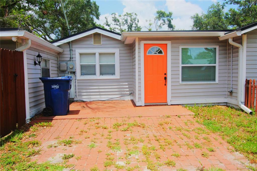 6602 North 9th Street Tampa, FL 33604 - Photo 3 of 22 a front view of a house with a yard and garage