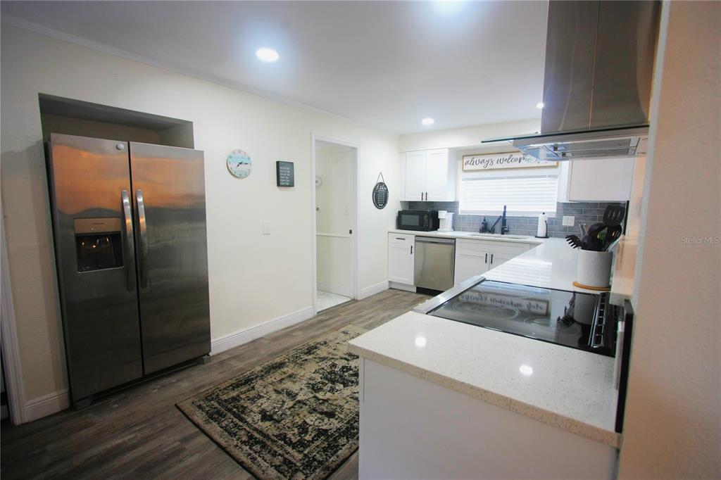 6602 North 9th Street Tampa, FL 33604 - Photo 6 of 22 a kitchen with a sink a refrigerator and cabinets