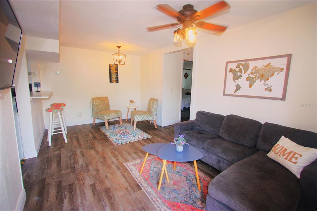 6602 North 9th Street Tampa, FL 33604 - Photo 10 of 22 a view of a livingroom with furniture and a wooden floor