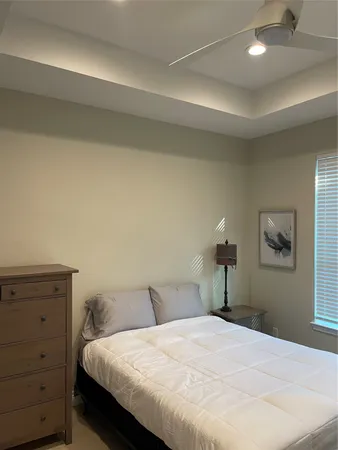 a bedroom with a bed and a night stand