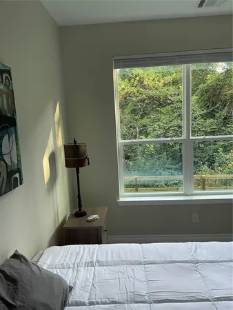 a living room with a bed furniture and a window