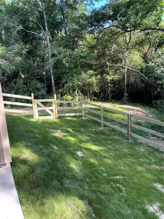 a big yard with trees in the background