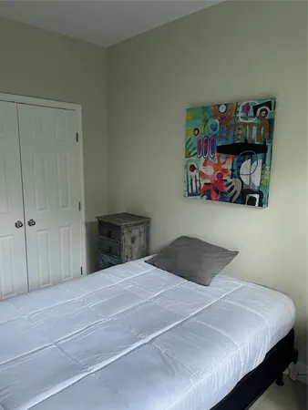 a bedroom with a bed and a book shelf