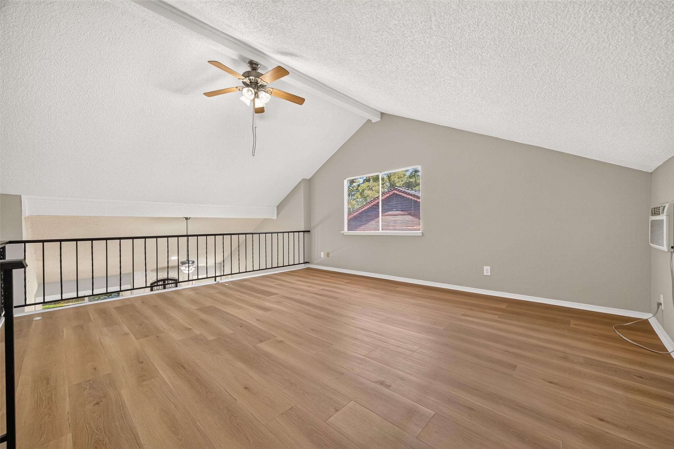 23219 Calico Corners Lane Spring, TX 77373 - Photo 19 of 24 Bright and spacious Game Room with vaulted ceilings, Vinyl plank flooring, and a ceiling fan, offering a versatile living space.