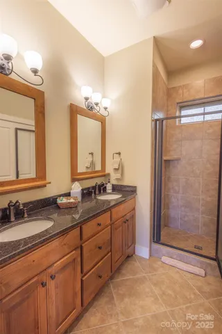 a bathroom with a granite countertop sink mirror and double