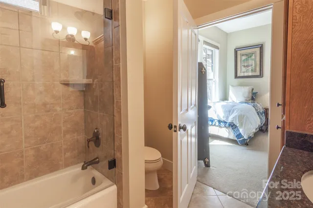 a bathroom with a tub shower sink and vanity