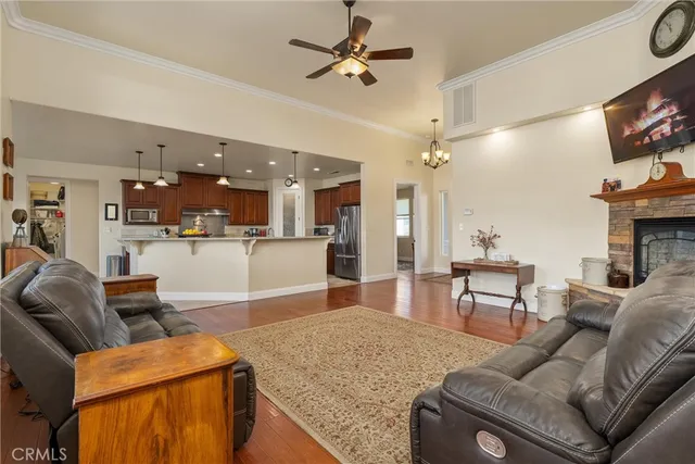 a kitchen with stainless steel appliances granite countertop a sink a stove and a refrigerator