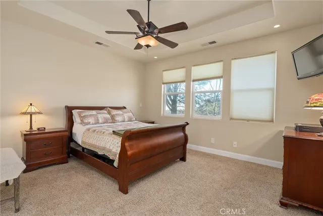 a patio with table and chairs and potted plants