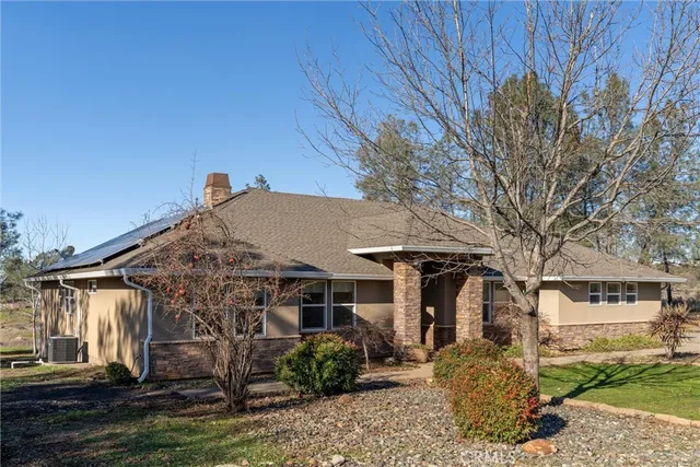 a view of a house with wooden deck and furniture