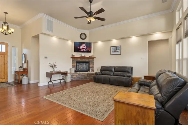 a dining room with furniture a chandelier and wooden floor