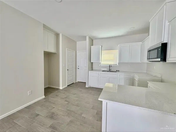 a kitchen with a sink a stove and cabinets