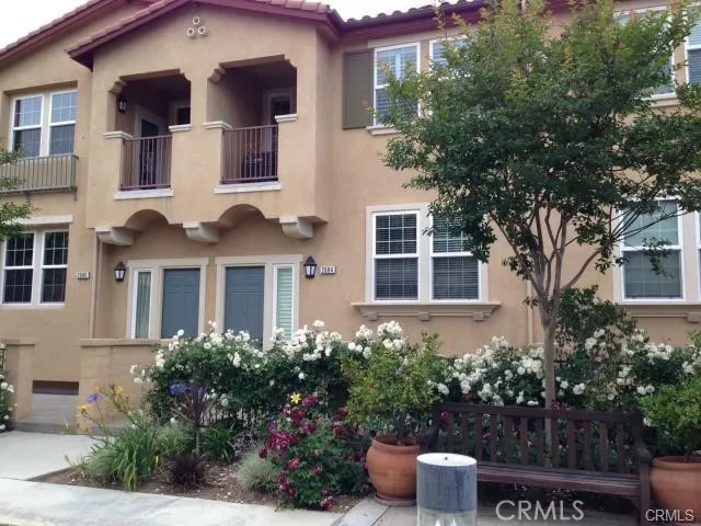a front view of a house with plants