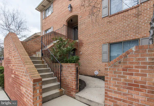 a view of a brick house with wooden walls and stairs