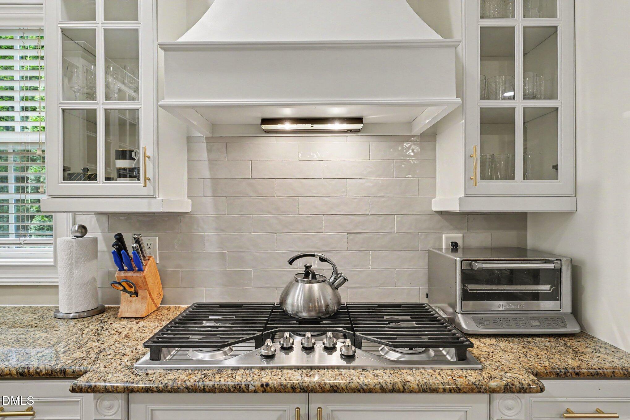 1729 Frenchwood Drive Raleigh, NC 27612 - Photo 9 of 46 a kitchen with a stove and cabinets