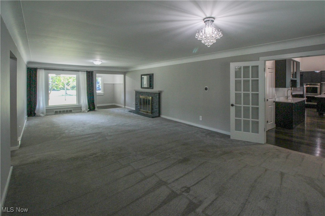 207 Harmon Road Aurora, OH 44202 - Photo 6 of 40 Living room with the foyer beyond and a view of the kitchen to the right.