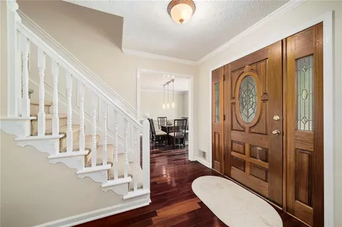 a view of entryway and hall with wooden floor