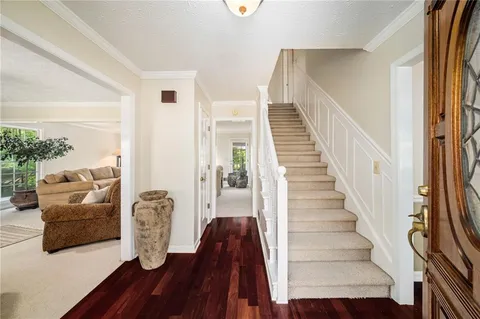 a view of entryway and hall with wooden floor
