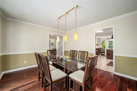 a view of a dining room with furniture and wooden floor