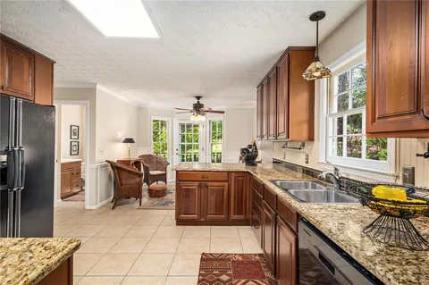 a kitchen with a sink a counter top space and stainless steel appliances