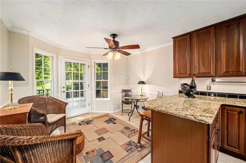 a kitchen with a stove a sink a dining table and chairs