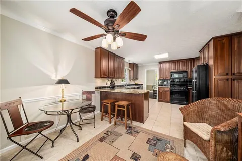 a kitchen with a refrigerator a dining table and chairs