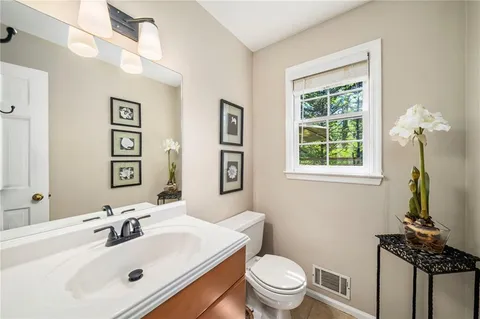 a bathroom with a sink a mirror and a toilet