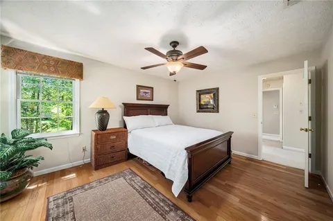 a bedroom with a bed and a potted plant