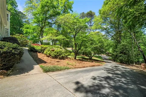 a backyard of a house with a yard and outdoor seating