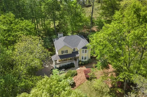 an aerial view of a house with a yard and outdoor seating