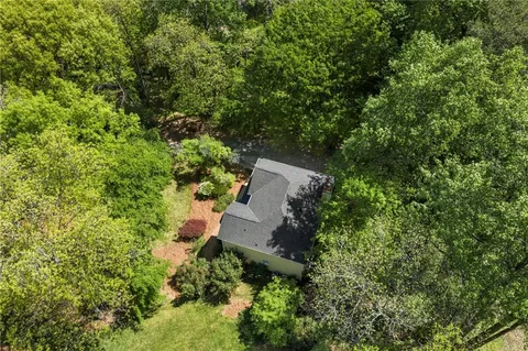 an aerial view of a house with a yard
