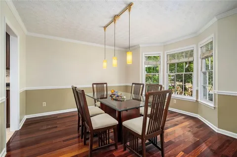a view of a dining room with furniture window and wooden floor